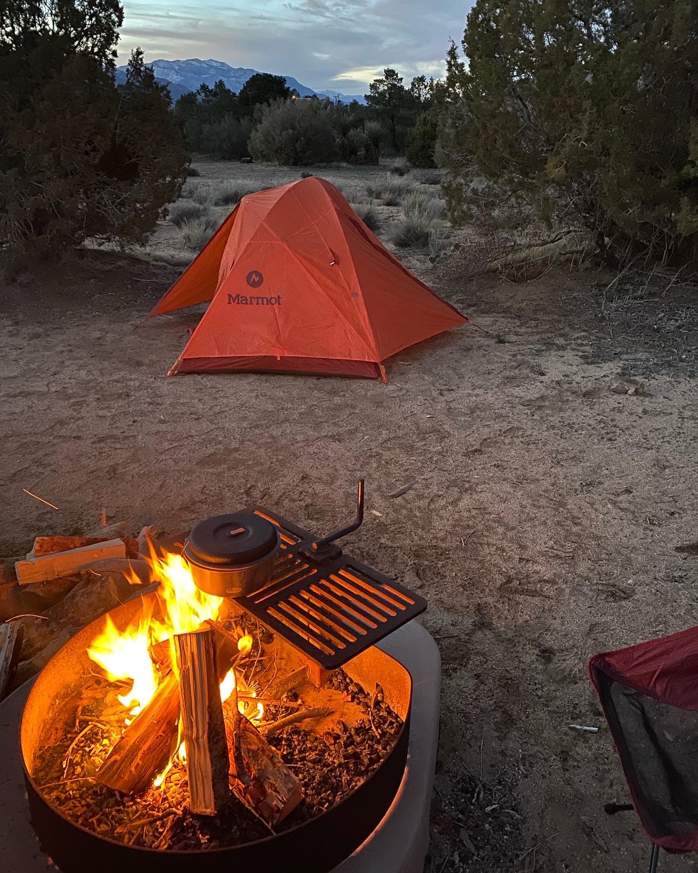 Tent and campfire at a campground in the southern California mountains. Camping