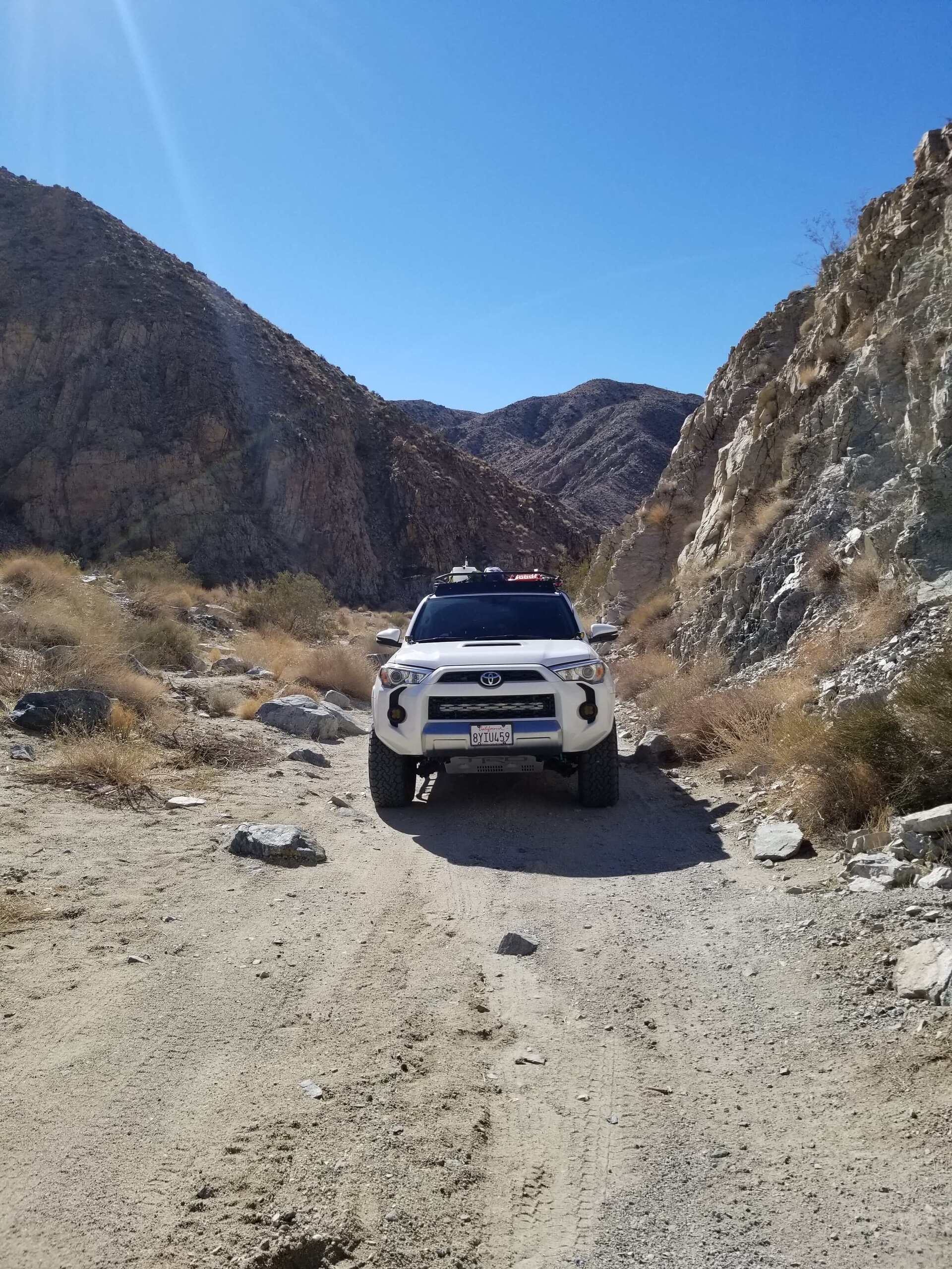White Toyota 4runner offroad in desert canyon near Joshua Tree National Park, CA
