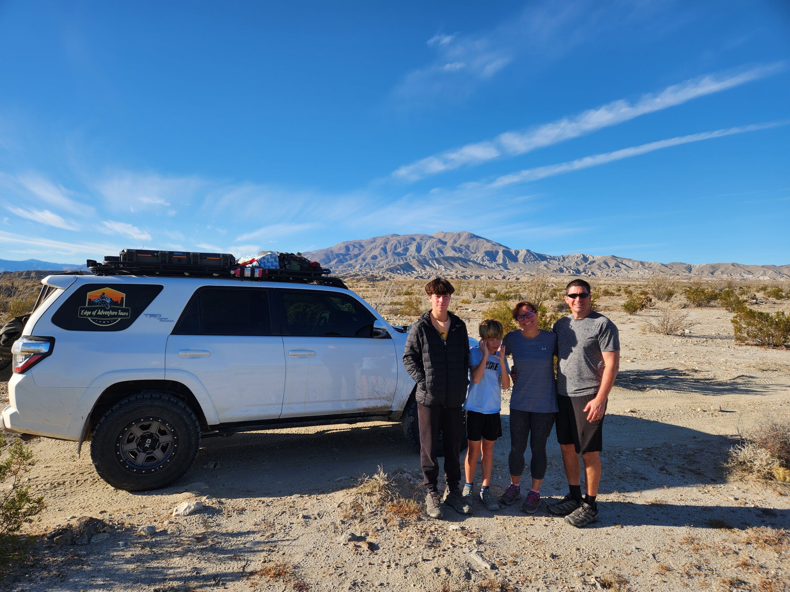 Family stands in front of a lifted Toyota 4runner in Anza Borrego Desert State Park